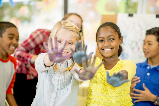 Gallery 1 - Children smiling with paint on hands